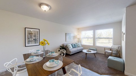 a living room and dining room with a table and chairs
